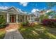 Inviting home with a red door, covered porch, a turret room, and manicured landscaping at 617 Hampton St, Walterboro, SC 29488