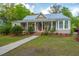 Charming single-story home with a metal roof, a covered front porch and landscaped front yard at 617 Hampton St, Walterboro, SC 29488