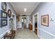 Welcoming hallway with wood-paneled walls, decorated with antique pictures and a carpet at 617 Hampton St, Walterboro, SC 29488