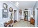 Charming hallway with wood-paneled walls, decorated with antique pictures and decor at 617 Hampton St, Walterboro, SC 29488