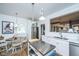 Bright kitchen featuring white cabinets, an island, stainless steel appliances, and a dining area at 617 Hampton St, Walterboro, SC 29488