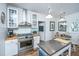 Bright kitchen featuring white cabinets, stainless steel appliances, and an island at 617 Hampton St, Walterboro, SC 29488
