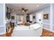 Bright living room with wood floors, white couches, and a gray accent wall at 617 Hampton St, Walterboro, SC 29488