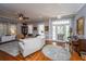 Cozy living room with hardwood floors, ceiling fan, and neutral-colored couches and decor at 617 Hampton St, Walterboro, SC 29488