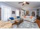 Comfortable living room with gray walls, ceiling fan, and couches with colorful pillows at 617 Hampton St, Walterboro, SC 29488