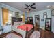Comfortable bedroom with a ceiling fan, hardwood floors, and traditional-style decor at 617 Hampton St, Walterboro, SC 29488