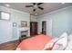 Comfortable bedroom with a fireplace, wood floors, and neutral wall color at 617 Hampton St, Walterboro, SC 29488