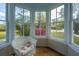 Bright sunroom with vintage chair at 617 Hampton St, Walterboro, SC 29488