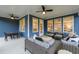 Covered outdoor patio with seating, ceiling fans, and blue siding at 630 Coral Bells Ln, Summerville, SC 29486
