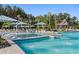 Resort-style pool area with sun loungers, umbrellas, and palm trees at 630 Coral Bells Ln, Summerville, SC 29486