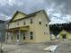 Side view of a charming two-story home under construction, featuring multiple windows and a covered porch at 715 Blueway Ave, Summerville, SC 29486