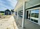 A long covered back porch offers relaxing outdoor living with views of the surrounding property at 721 Blueway Ave, Summerville, SC 29486