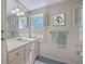 Bright bathroom with marble countertop, classic fixtures, and shuttered windows for ample natural light and privacy at 73 Anson St, Charleston, SC 29401