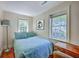 Cozy bedroom with hardwood floors, ample natural light, and comfortable furnishings, creating a relaxing space at 73 Anson St, Charleston, SC 29401