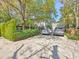 Spacious driveway with parked cars leading to a beautifully maintained home and landscape at 73 Anson St, Charleston, SC 29401