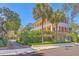Elegant two-story home with a double balcony surrounded by lush greenery and palm trees at 73 Anson St, Charleston, SC 29401