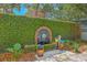 Beautiful ivy-covered wall featuring a decorative brick fountain and manicured garden at 73 Anson St, Charleston, SC 29401