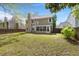 The large backyard features a sunroom, mature trees and a wood fence at 8499 Falling Leaf Ln, North Charleston, SC 29420