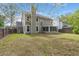 The large backyard features a sunroom, mature trees and a wood fence at 8499 Falling Leaf Ln, North Charleston, SC 29420