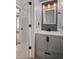 Modern bathroom with stone backsplash, vanity and framed mirror at 8499 Falling Leaf Ln, North Charleston, SC 29420