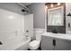 Stylish bathroom showcasing shower-tub combination with stone backsplash and granite countertop at 8499 Falling Leaf Ln, North Charleston, SC 29420