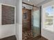 Bathroom features include a stone accent wall, wainscotting and frameless glass shower at 8499 Falling Leaf Ln, North Charleston, SC 29420