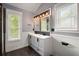 Bathroom boasts updated vanity with double sinks, stylish lighting, and modern fixtures at 8499 Falling Leaf Ln, North Charleston, SC 29420