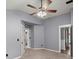 Bedroom features neutral colors, ceiling fan, carpet and two doorways at 8499 Falling Leaf Ln, North Charleston, SC 29420