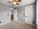 Neutral bedroom with carpet, ceiling fan, and two doors at 8499 Falling Leaf Ln, North Charleston, SC 29420