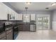 Modern kitchen with granite countertops, stainless steel appliances, and tile floors at 8499 Falling Leaf Ln, North Charleston, SC 29420