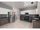 Open kitchen with stainless steel appliances, granite countertops, and tile floors at 8499 Falling Leaf Ln, North Charleston, SC 29420