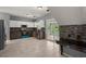 Modern kitchen with gray cabinetry, stainless steel appliances, tile backsplash, and access to the patio at 8499 Falling Leaf Ln, North Charleston, SC 29420