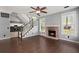 Inviting living room with a brick fireplace, staircase, hardwood floors, and plenty of natural light at 8499 Falling Leaf Ln, North Charleston, SC 29420