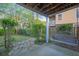 View of backyard patio with wooden swing, lush greenery, and stone path at 9028 Parlor Dr, Ladson, SC 29456