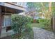 Backyard with swing, flagstone path, mature trees and greenery at 9028 Parlor Dr, Ladson, SC 29456