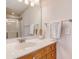 Bathroom featuring single vanity with white countertop, a large mirror, and shower with glass door at 9028 Parlor Dr, Ladson, SC 29456