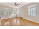 Bedroom with hardwood floors and natural light from three large windows at 9028 Parlor Dr, Ladson, SC 29456