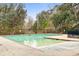 Large community pool with a concrete deck and mature trees in the background at 9028 Parlor Dr, Ladson, SC 29456