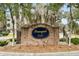Brick community sign with mature landscaping and Spanish moss-draped trees at Tranquil Hill at 9028 Parlor Dr, Ladson, SC 29456