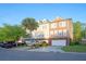 View of townhomes showing brick facades, white garage doors, palm tree and front yards at 9028 Parlor Dr, Ladson, SC 29456