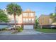 A row of townhouses with brick facades, driveways, and a well-maintained green space at 9028 Parlor Dr, Ladson, SC 29456