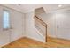 Bright foyer features wood floors, staircase, and multiple entry and access doors at 9028 Parlor Dr, Ladson, SC 29456