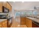 Bright kitchen featuring wood cabinets, stainless steel appliances, and an open view of the living room at 9028 Parlor Dr, Ladson, SC 29456