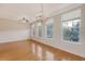 Living room with hardwood floors, natural light, ceiling fan and wainscoting at 9028 Parlor Dr, Ladson, SC 29456