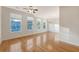 Bright living room with hardwood floors, large windows, and modern chandelier at 9028 Parlor Dr, Ladson, SC 29456
