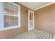 Inviting porch with wood flooring and an adjacent window showcasing a cozy outdoor retreat at 9028 Parlor Dr, Ladson, SC 29456