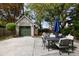 Spacious backyard with patio seating, a detached garage, and an umbrella for shade at 956 Provincial Cir, Mount Pleasant, SC 29464