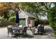 Cozy backyard patio featuring outdoor seating and a charming garage with a green door at 956 Provincial Cir, Mount Pleasant, SC 29464