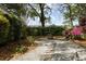 Beautiful backyard featuring a stone pathway, lush greenery, and privacy fencing at 956 Provincial Cir, Mount Pleasant, SC 29464