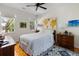 Bright bedroom with hardwood floors, neutral walls, and a comfortable bed with decorative pillows at 956 Provincial Cir, Mount Pleasant, SC 29464